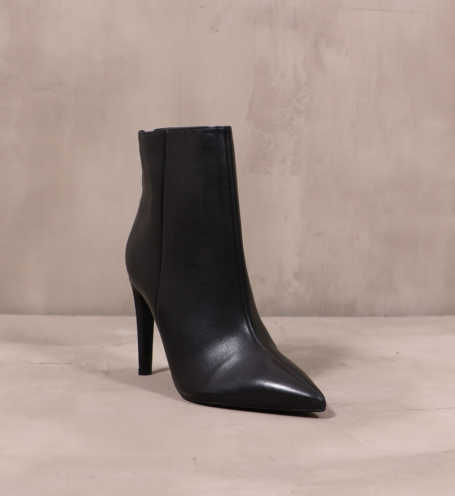 front of the pointed toe noir or never heel on cement background
