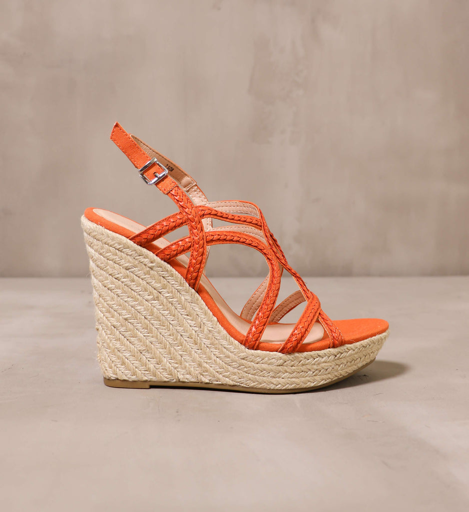 outer side of the braid for walking wedge with braided raffia wrapped sole and orange straps