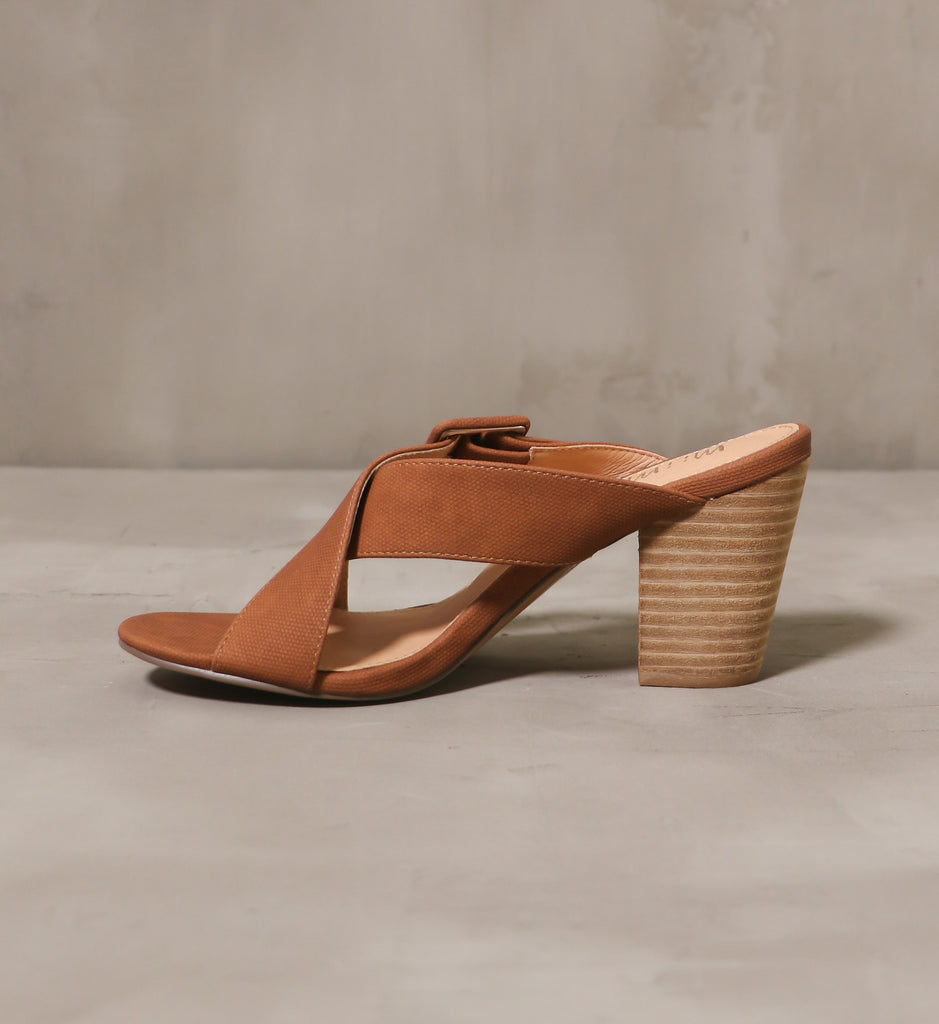 inner side of the buckle or nothing heel with criss cross straps and beige leather insole