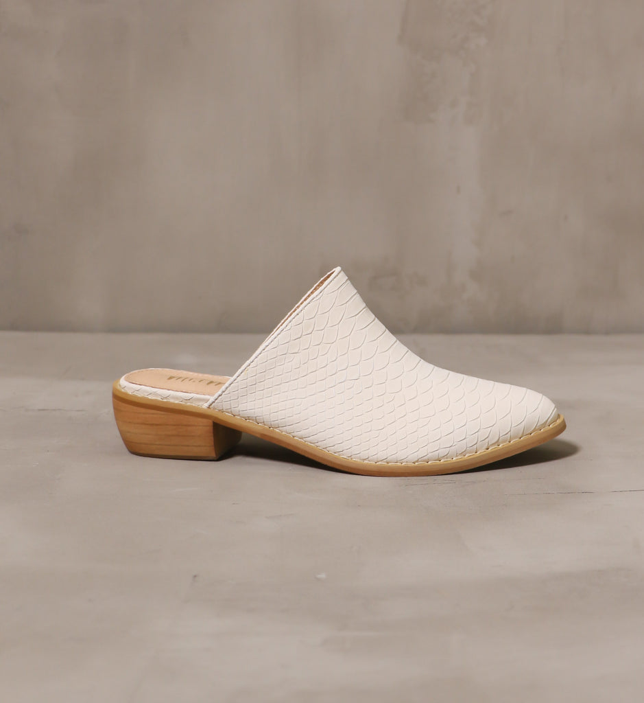 outer side of the cream of the croc mule with open back and stacked wood sole