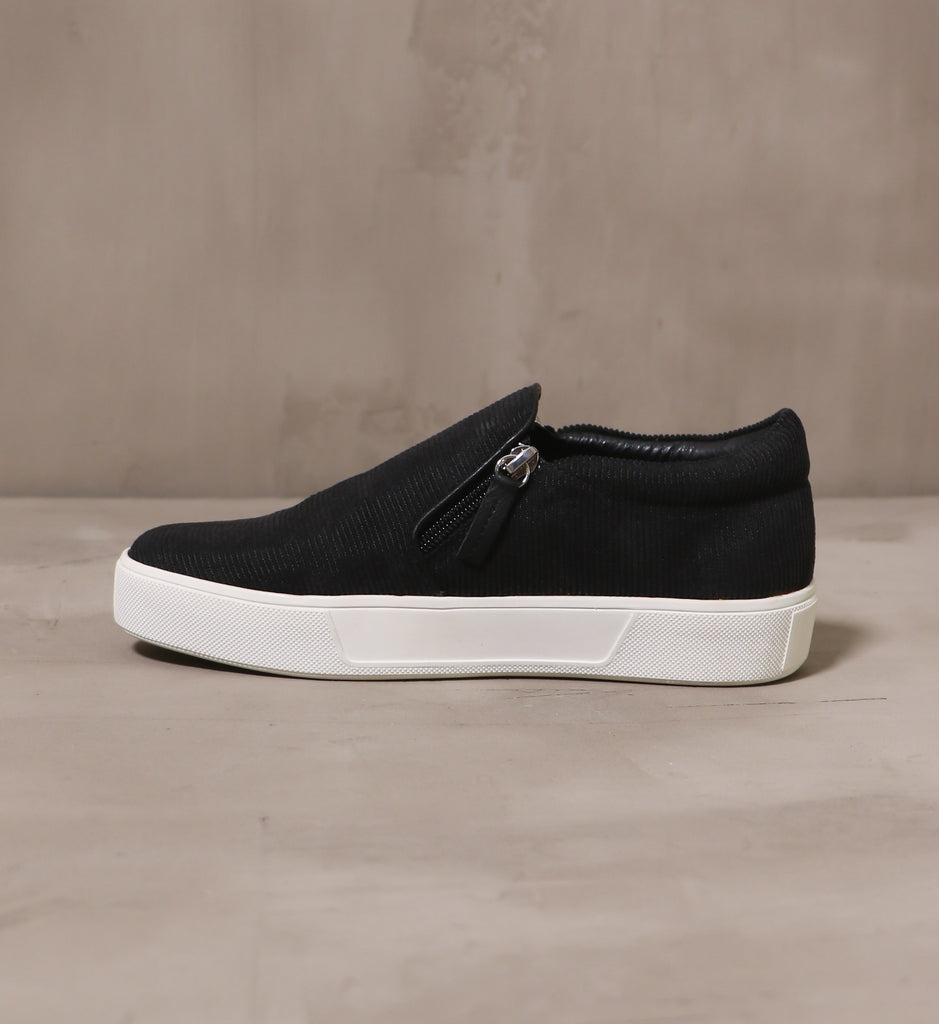 inner side of the black corduroy meets world sneaker with side zipper pull detail