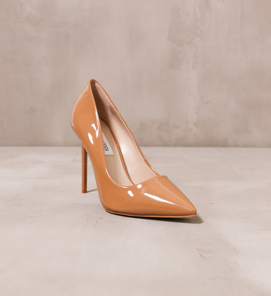 front of the pointed toe tan patent leather double pump latte heel