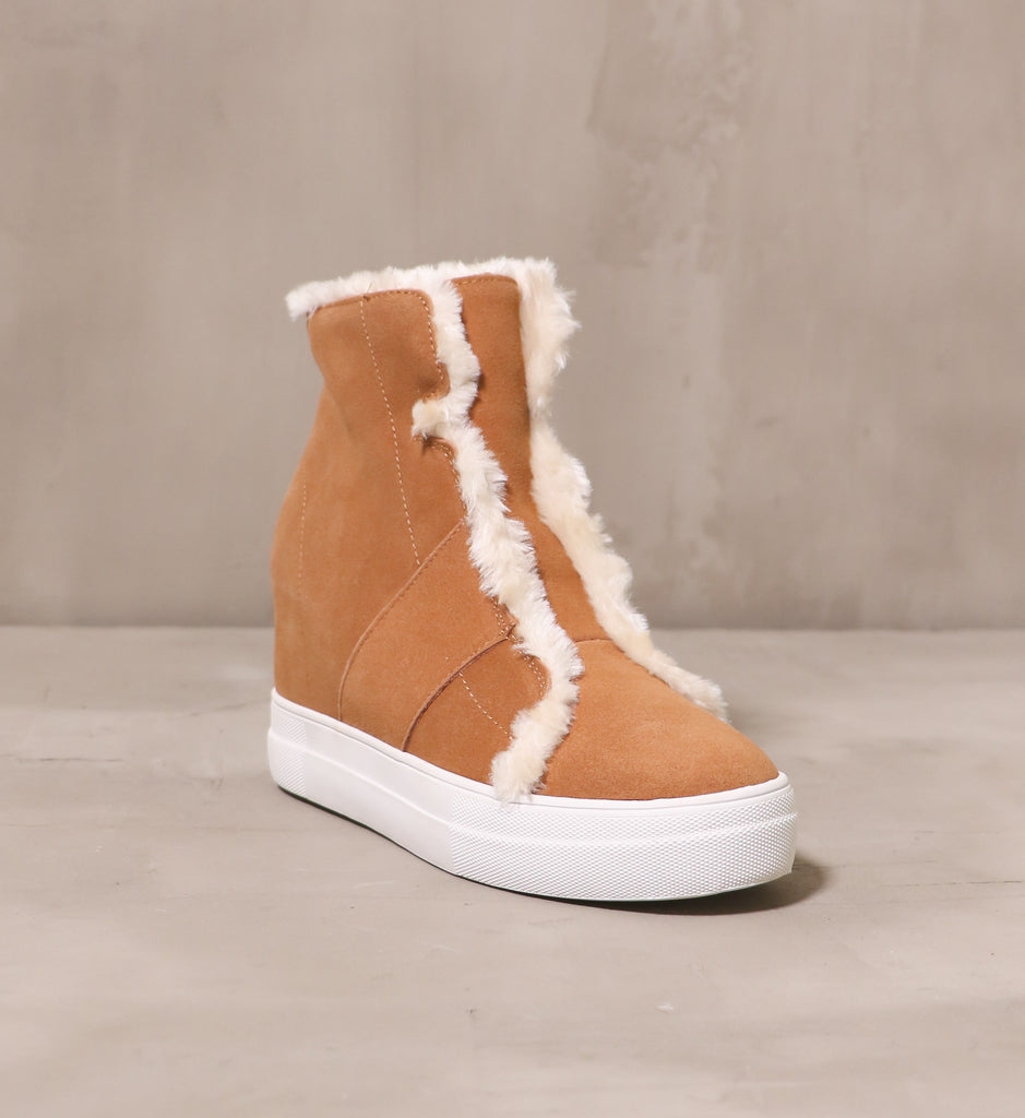 front of the round toe fur wedge and fur all wedge with tan suede upper and cream fur trim