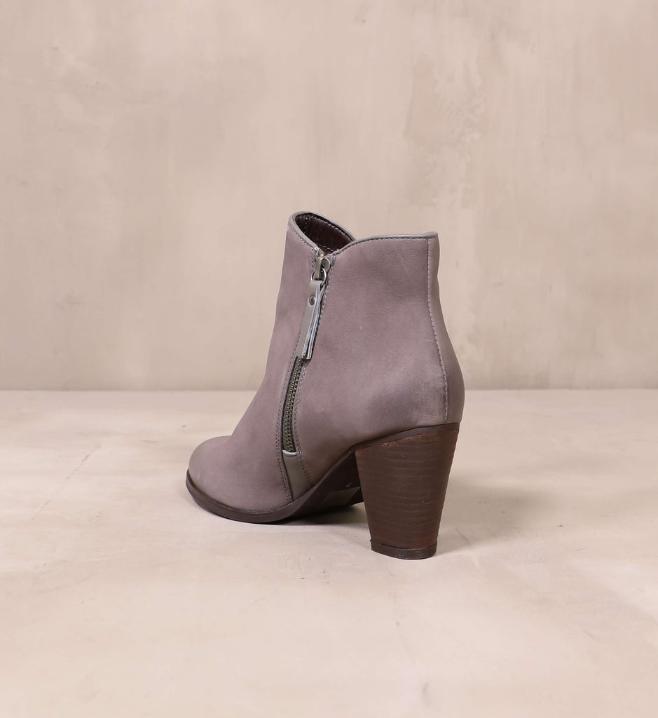 back of the stacked wood dark brown tapered heel on the heart zips a beat bootie