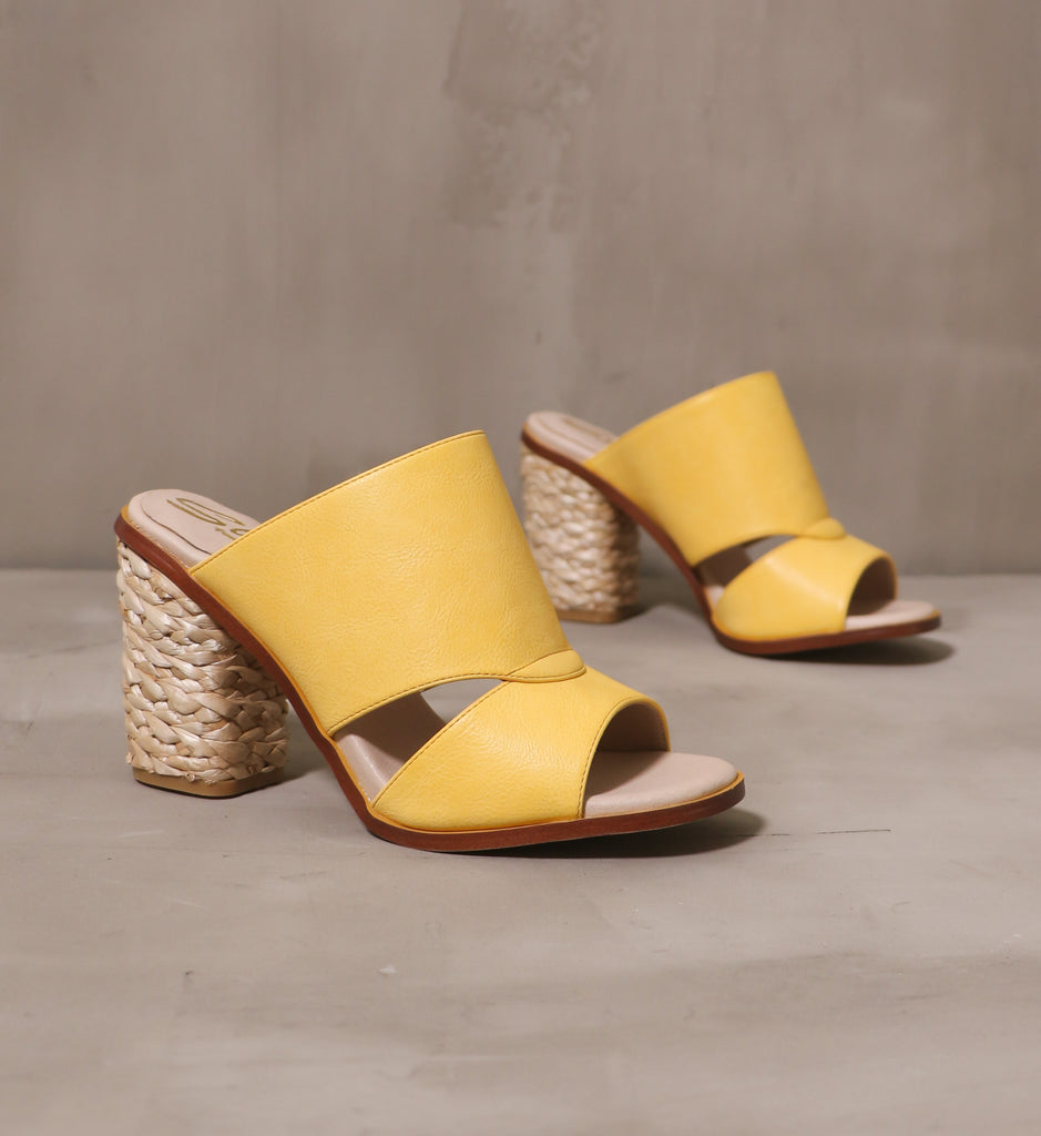pair of hello yellow open toe and back heels on cement background