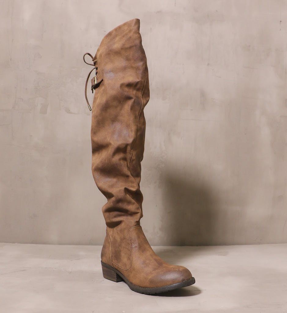 front of the round toe I knee'd a drink boot with slouchy distressed leather brown upper