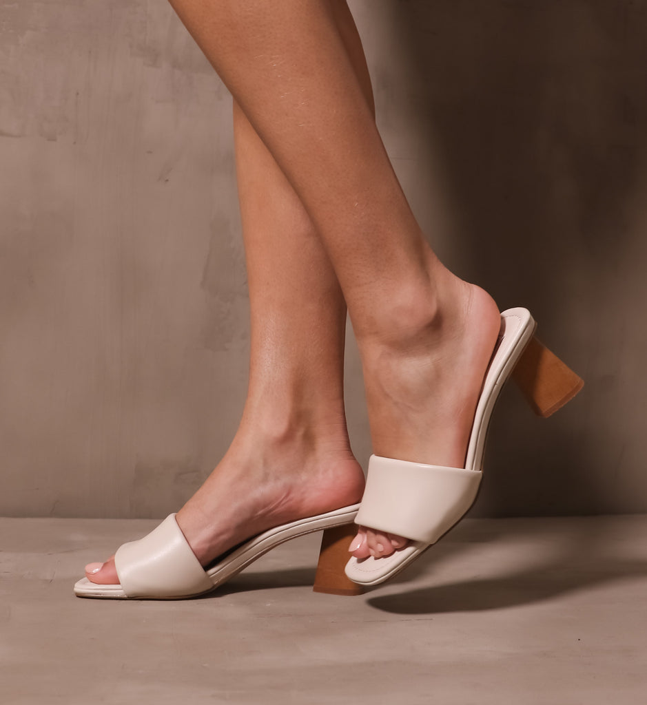 model walking on cement background in the modern kinda gal heels