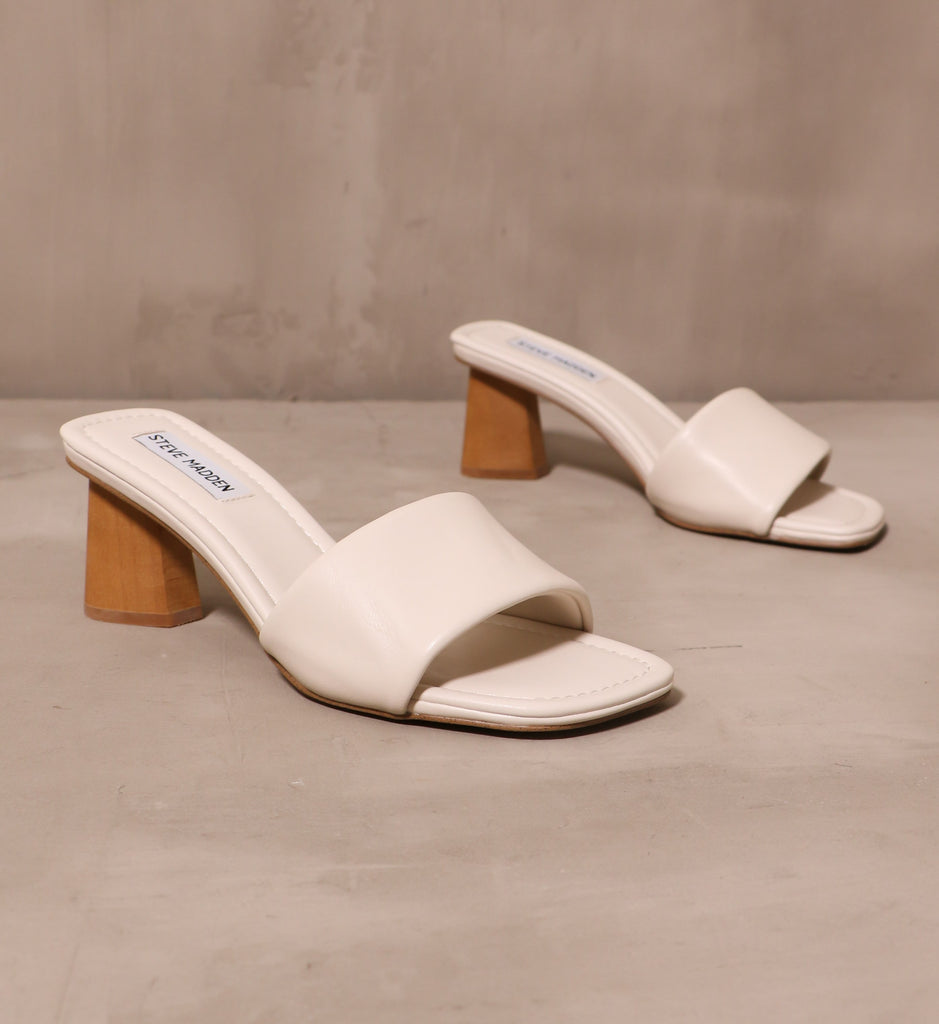 modern kinda gal heels with square toe bed and leather strap across the bridge