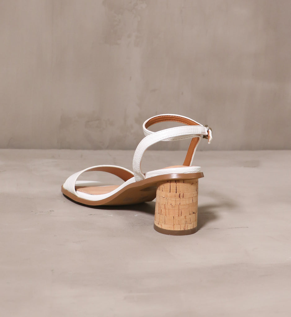 back of the cork block heel and thin white ankle strap on the pop the cork heel