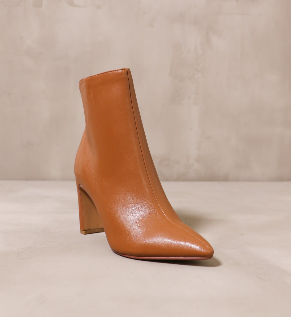 front of the pointed toe sleek step ankle boot with leather upper