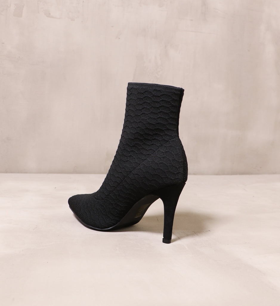 back of the textured black upper and stiletto heel on the sock it to me bootie