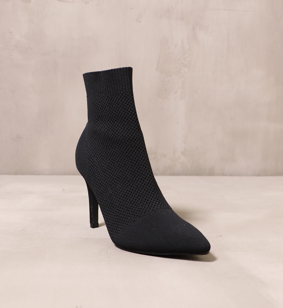 front of the pointed toe sock it to me bootie with fabric upper