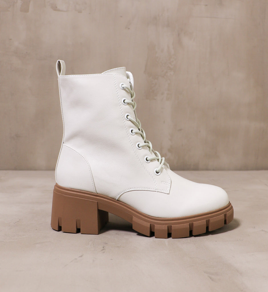 outer side of the speed of white boots with chunky rubber lug sole and heel