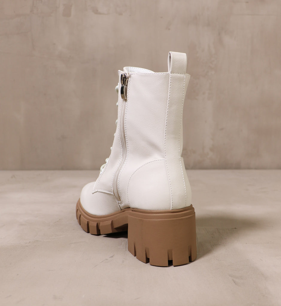 back of the speed of white leather boot with chunky rubber lug brown sole and leather pull tab at time