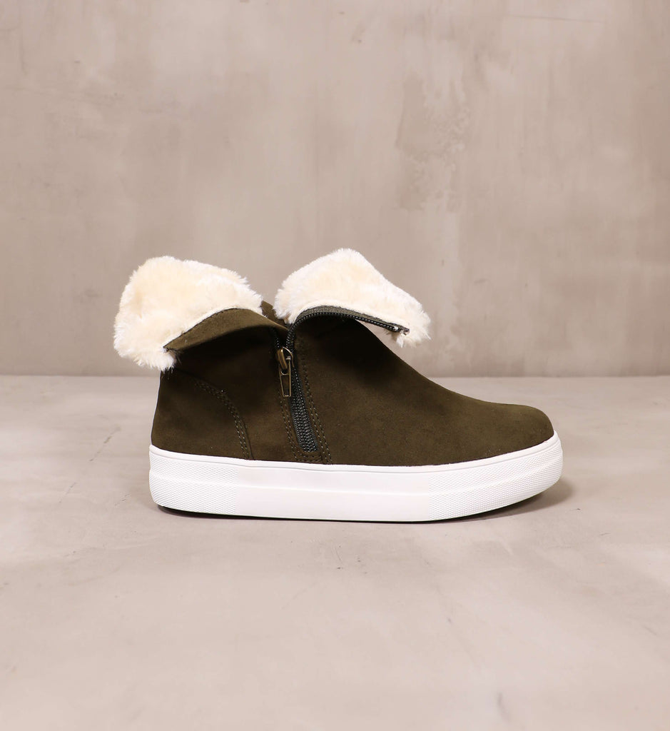 outer side of the olive green take it outside convertible sneaker with folded over upper and chunky white rubber sole