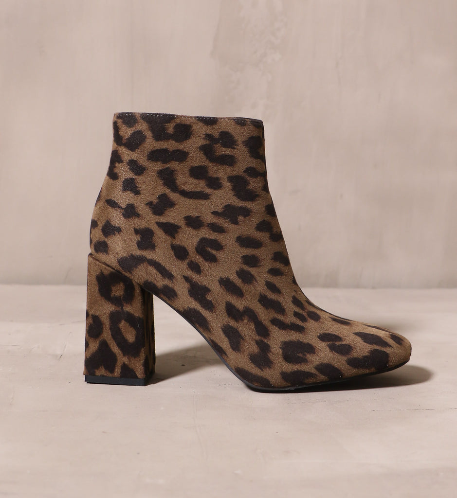 outer side of the cat's meow ankle boot with leopard green and black printed upper