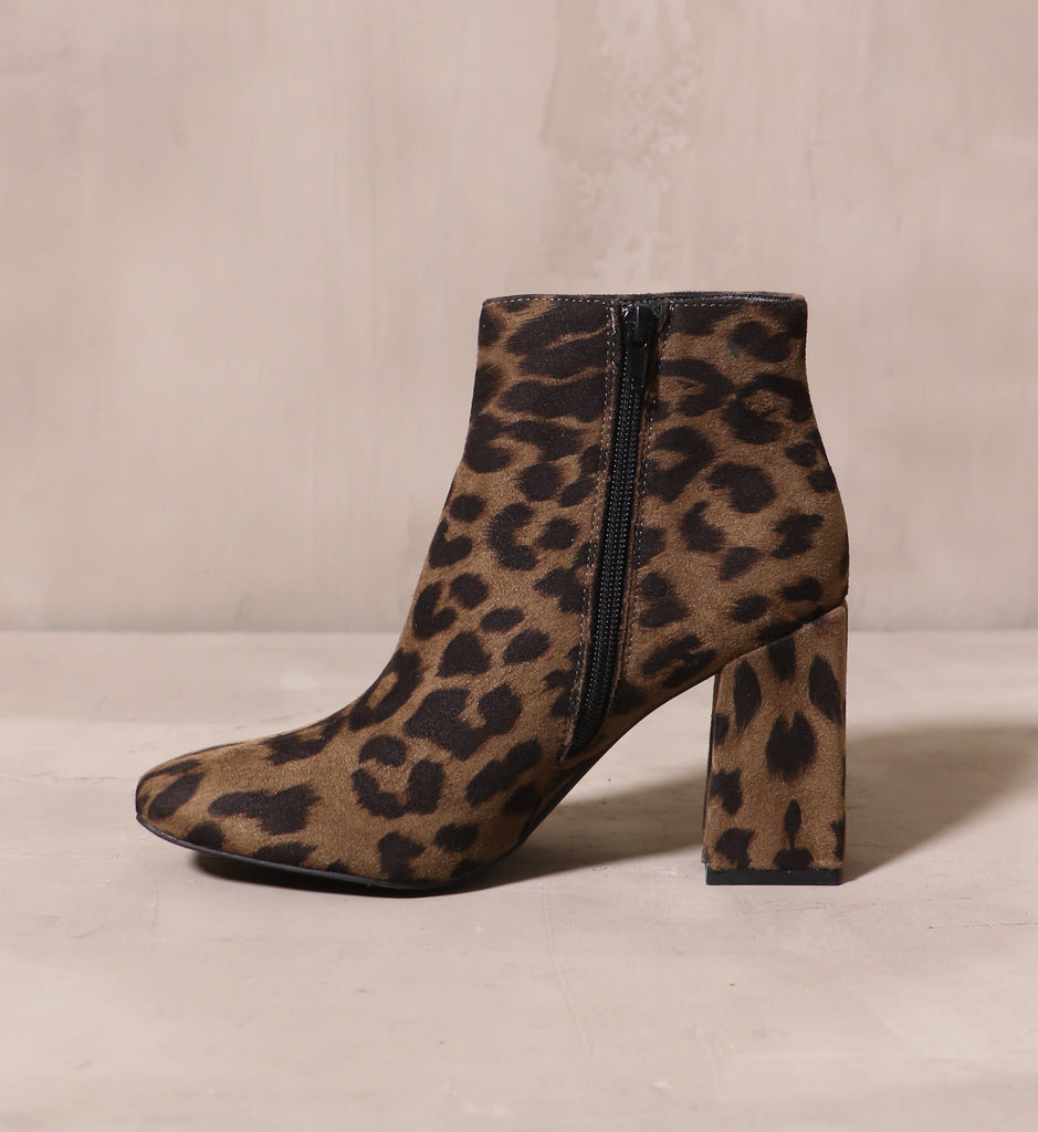 inner side of the black zipper on the olive and black cat's meow fabric ankle boot