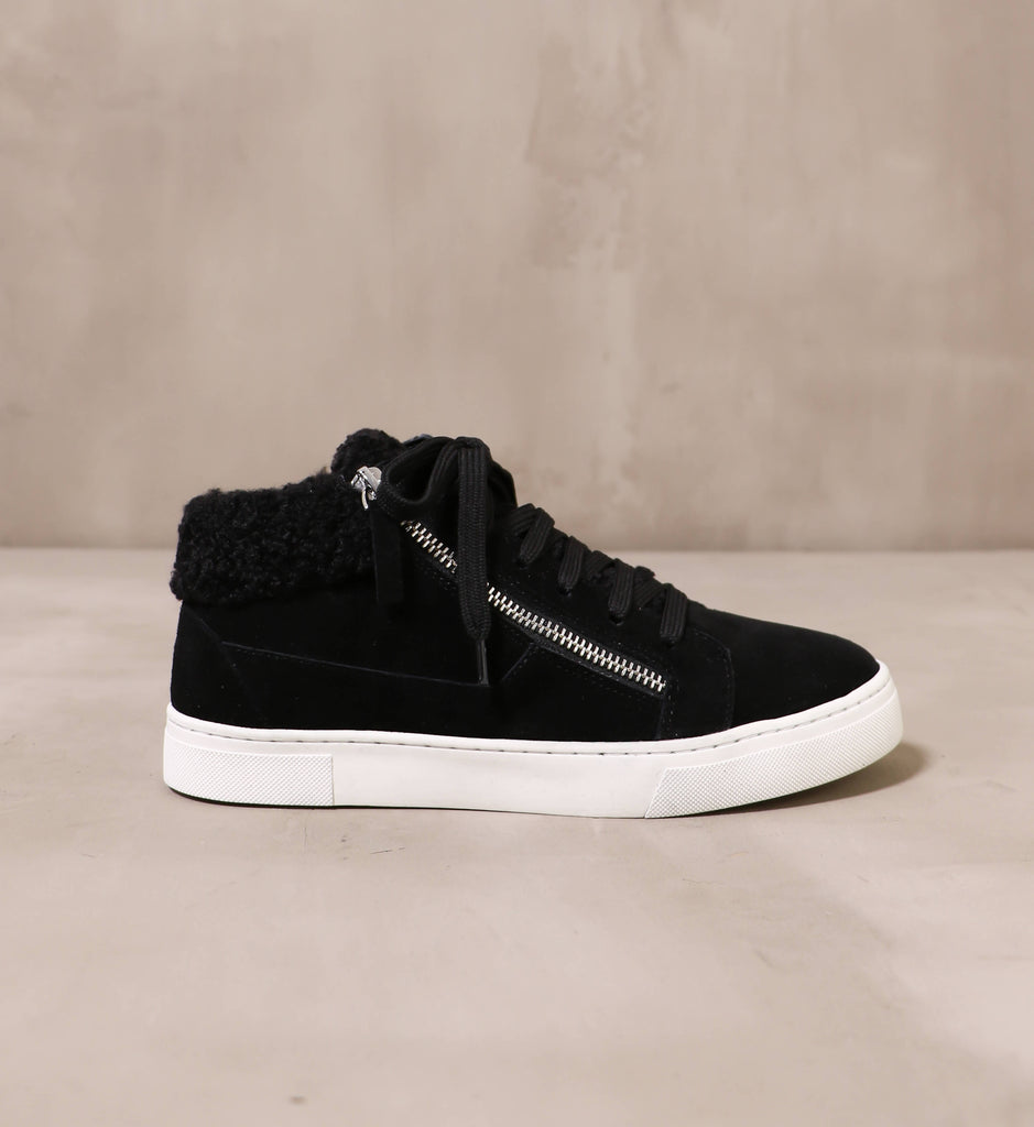 outer side of the silver zipper detail and black fur trim on the warm feelings sneaker
