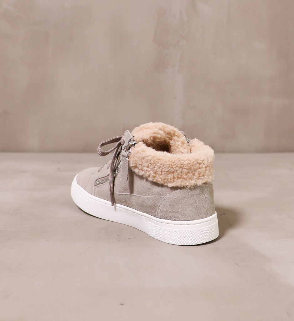 back of the taupe suede warm feelings sneaker with beige faux fur trim