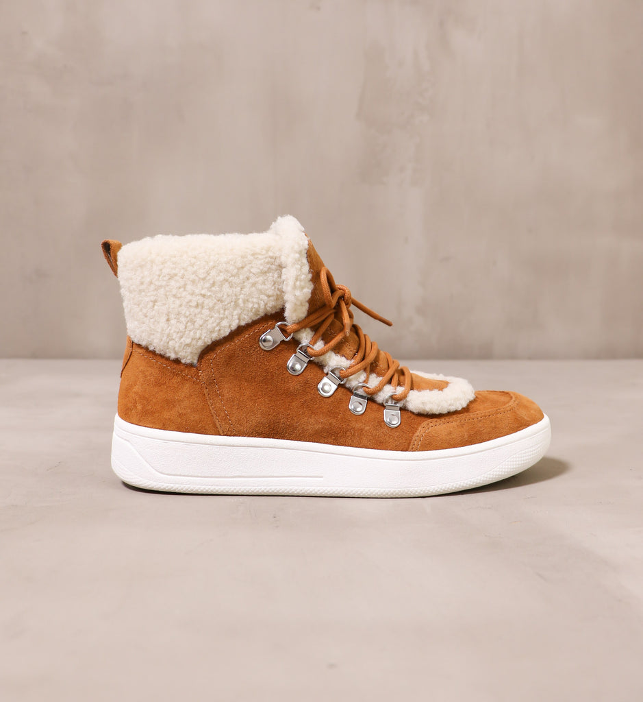 outer side of the warming signs tan suede upper and white rubber sole