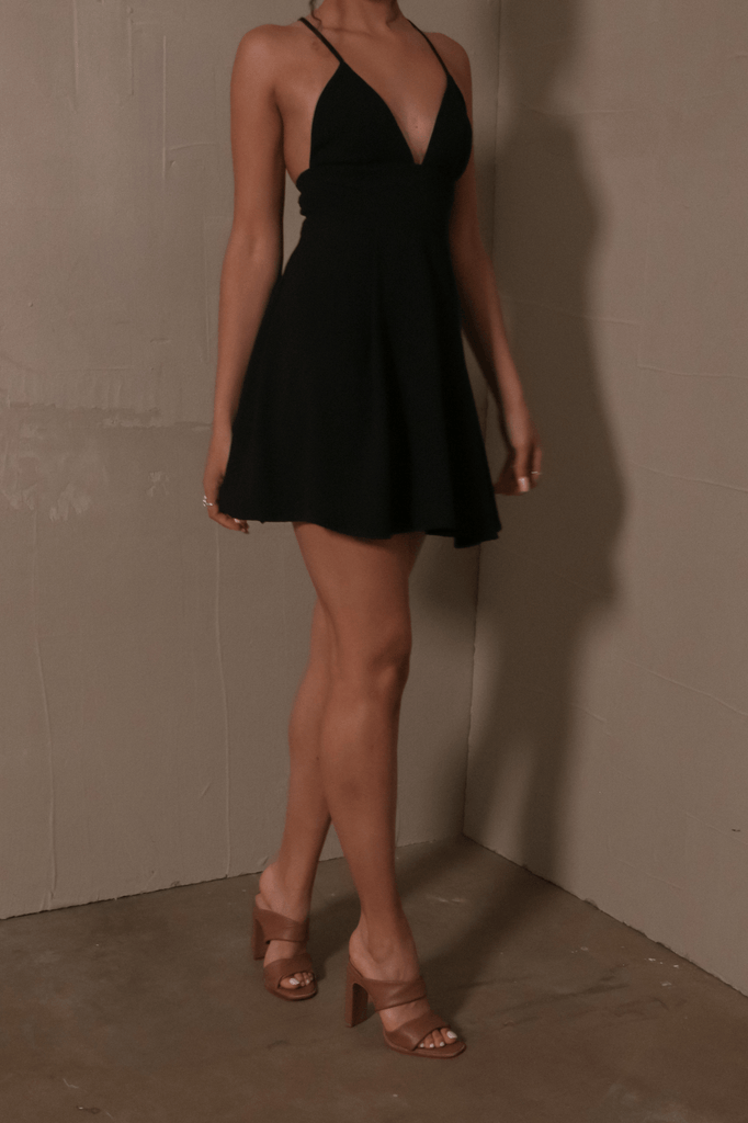 model standing in little black dress lbd and tan leather state of luxe aesthetic heels