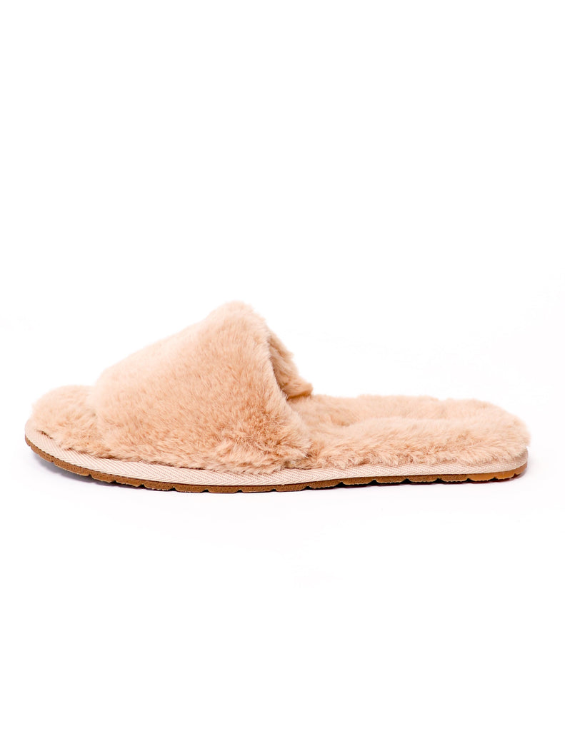 Faux fur cozy for you natural colored slippers on white background