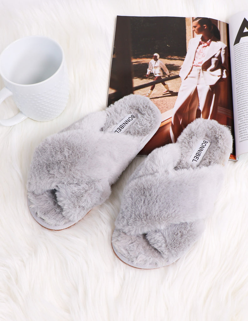 Grey fur the dreamers slipper on magazine and white fur rug - elle bleu
