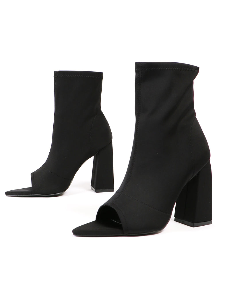 Sit tight black heeled booties on white background - elle bleu shoes