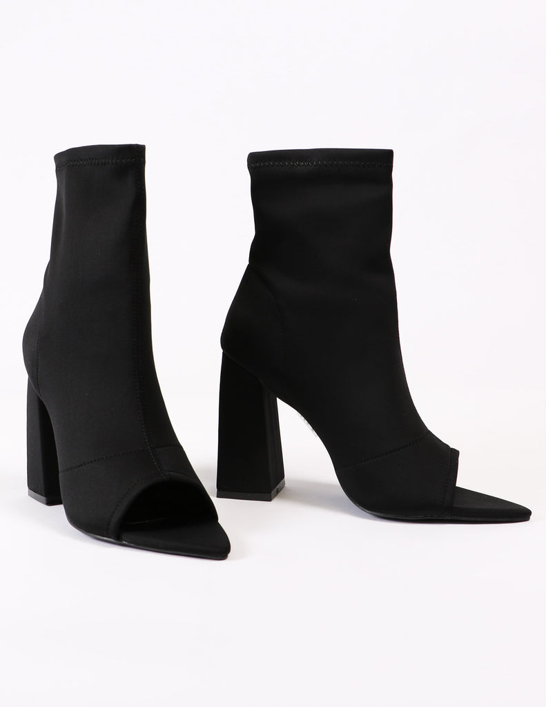 Black sit tight bootie with open toe and pointed footbed