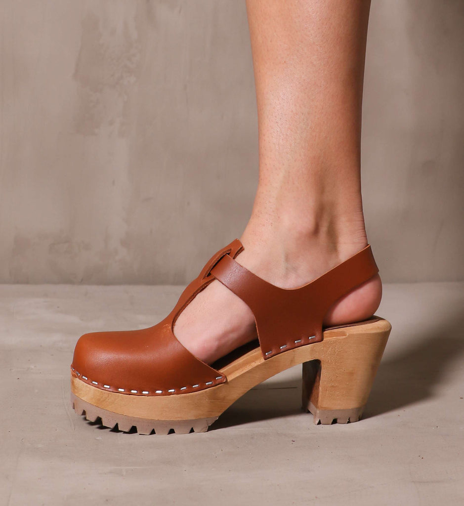 inner side of the brown leather madeline t strap clog with solid wood platform sole