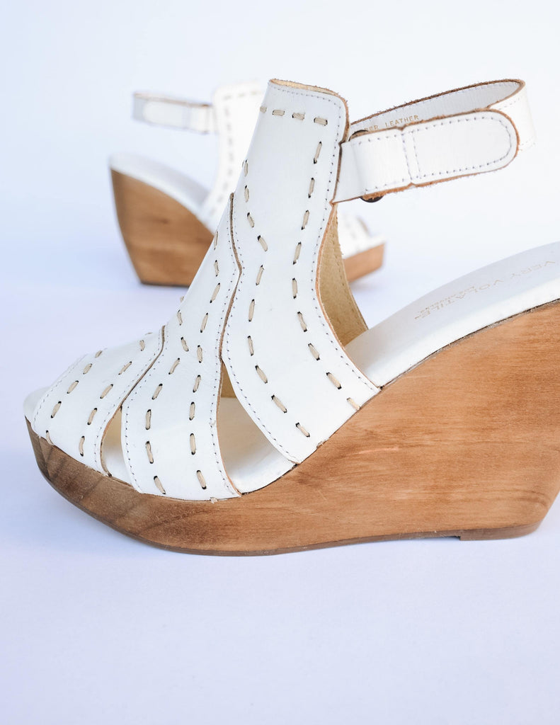 White bolanos wedge with tan wester inspired stitching and tan wood heel
