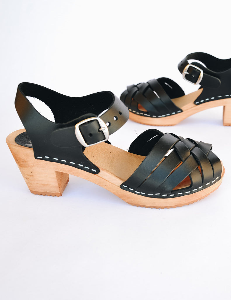 Black mia bety clog with woven upper and adjustable buckle ankle strap