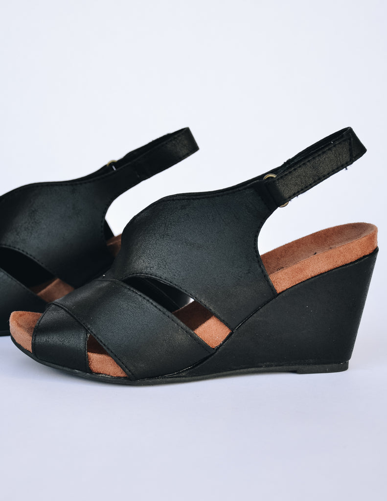 Black distressed faux suede upper with velcro back trap and fabric covered wedge