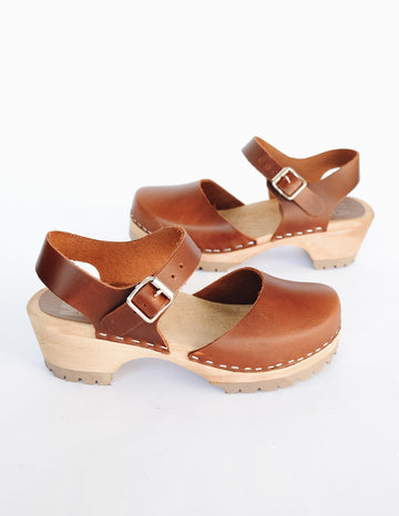 Luggage brown freja clog with closed toe and ankle strap on wood sole