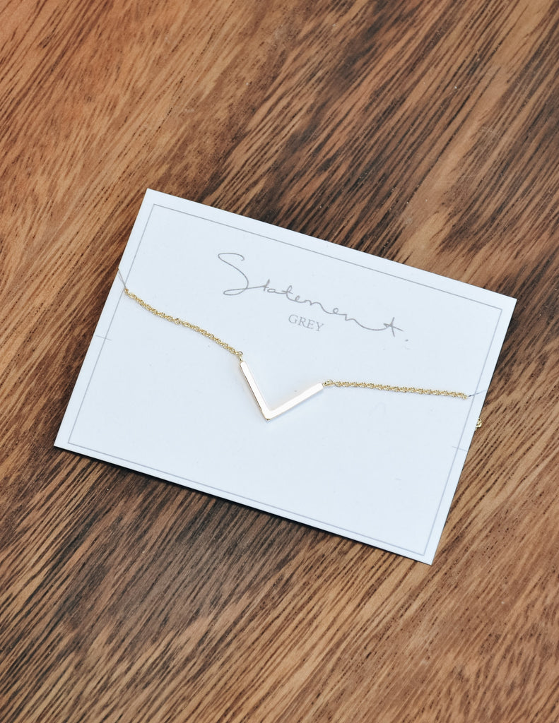 Gold chevron necklace on statement grey white card - elle bleu