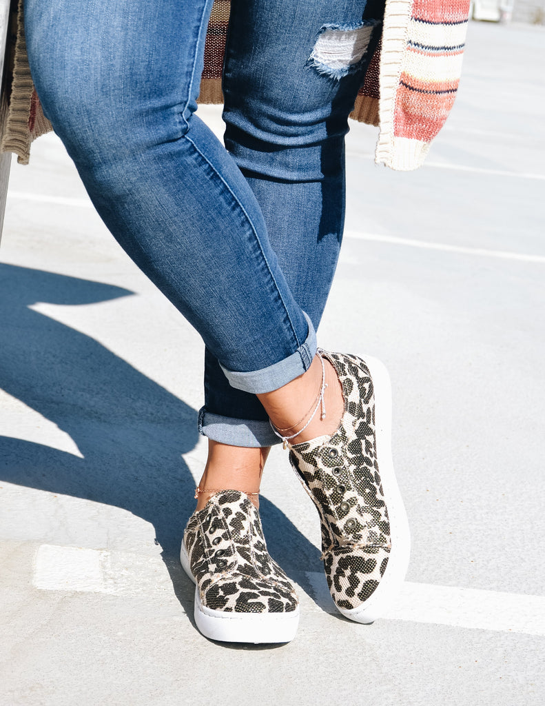 Model standing crossing legs in leopard get your sneak on sneakers - elle bleu
