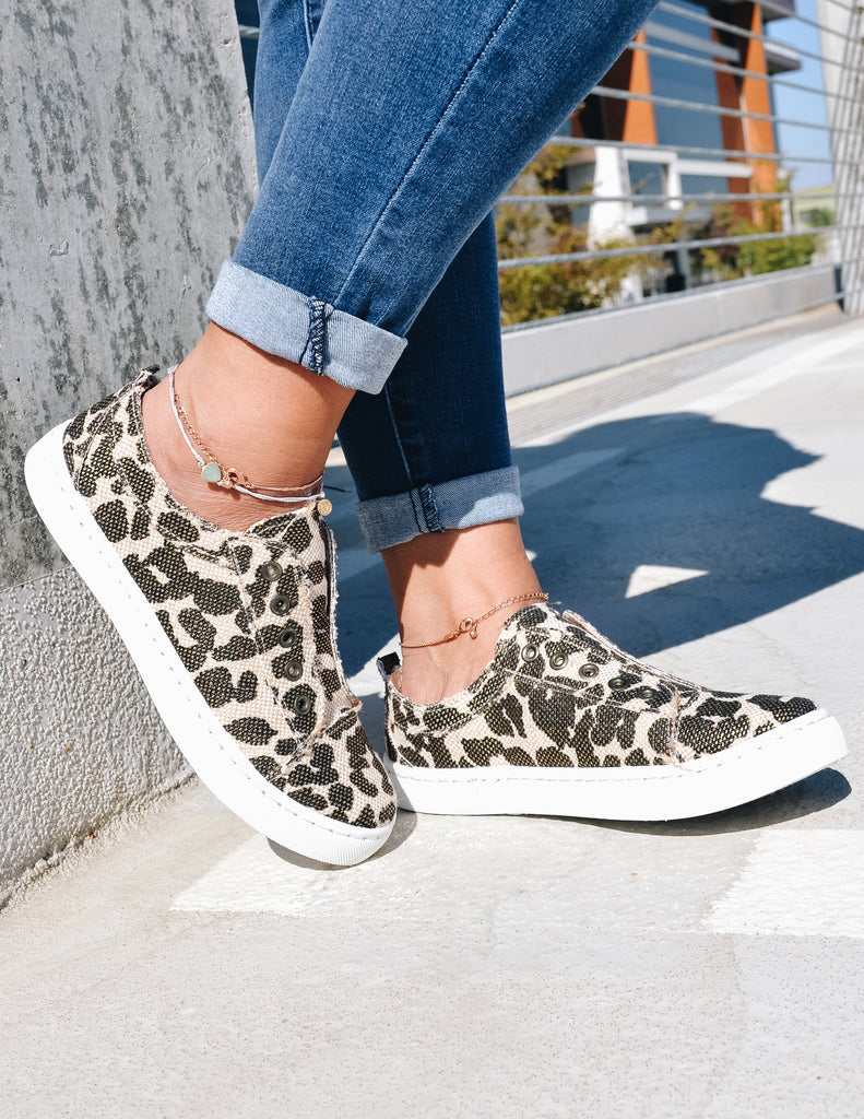 Closeup of model standing in get your sneak on leopard sneaker