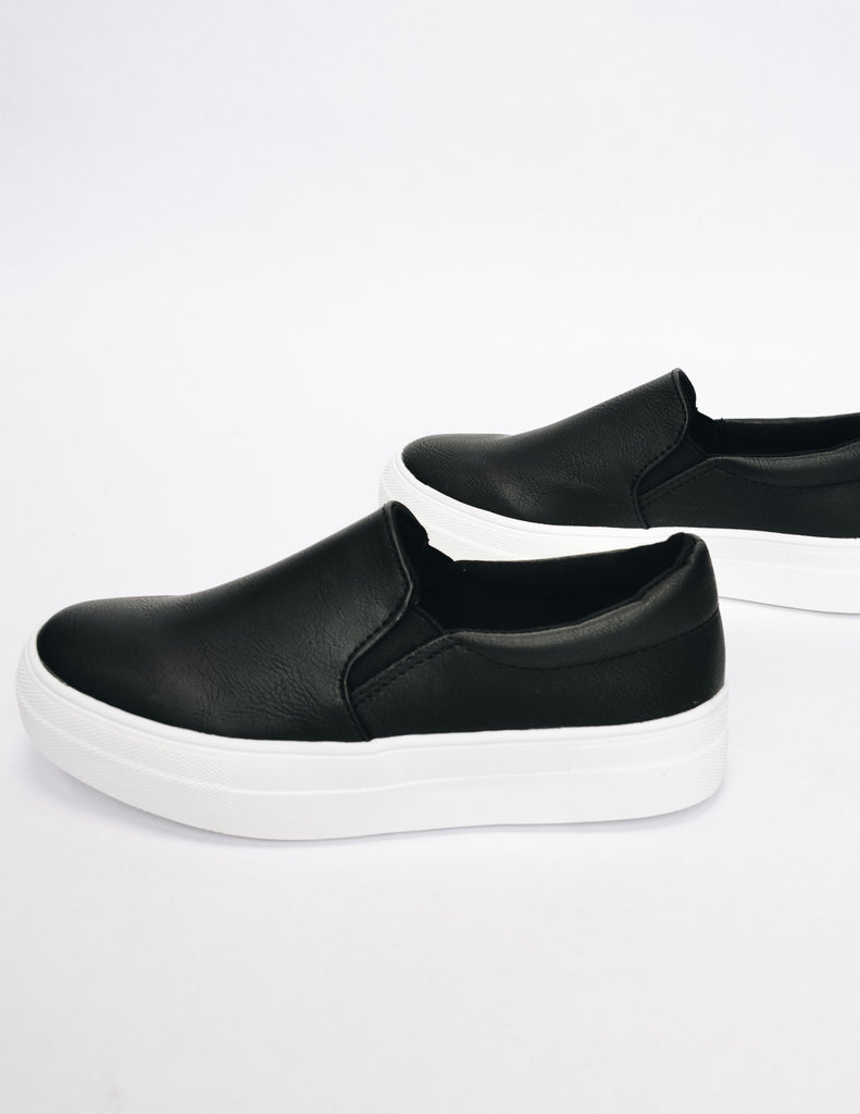 Side view of black slip on sneaker showing off elastic gores
