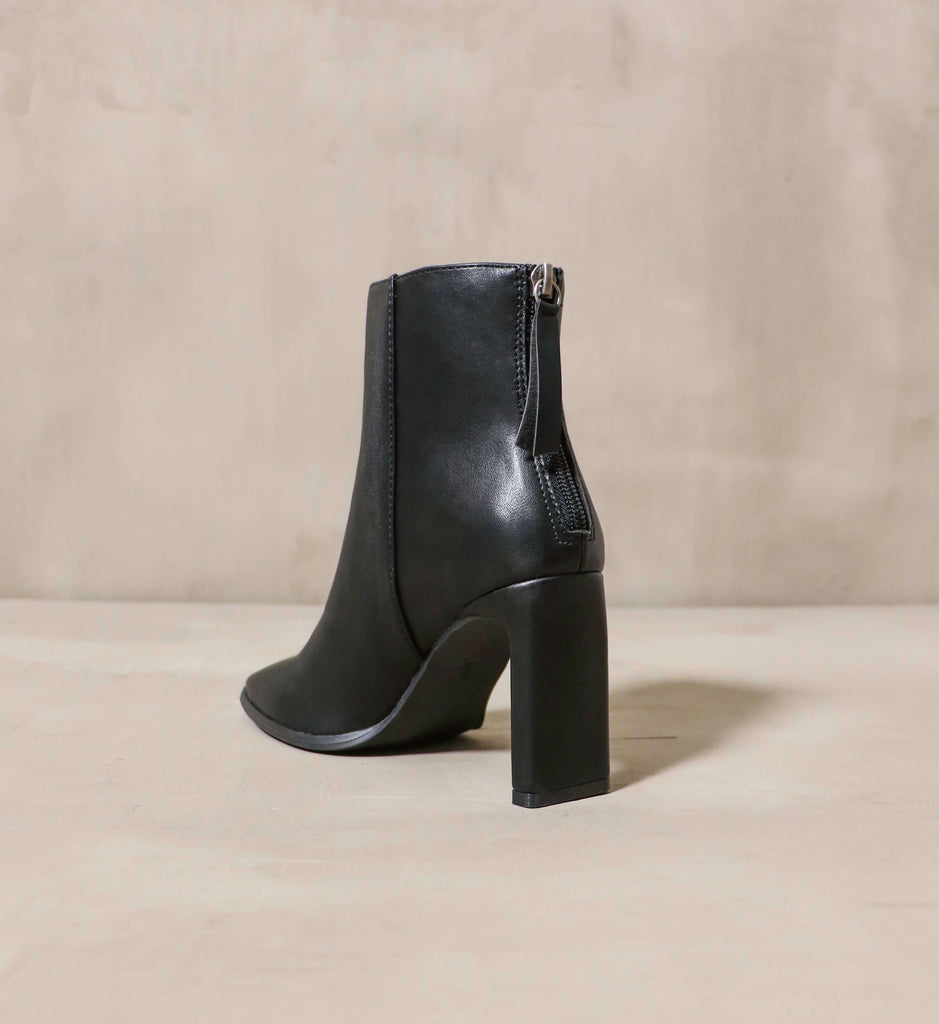 The zipper on the back of the black Not that Basic bootie- Elle Bleu