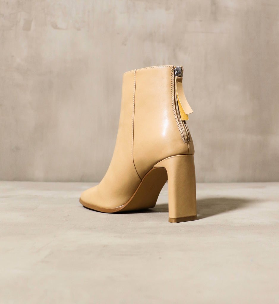 A view of the thin rectangular heel on the Not that Basic bootie in natural - Elle Bleu