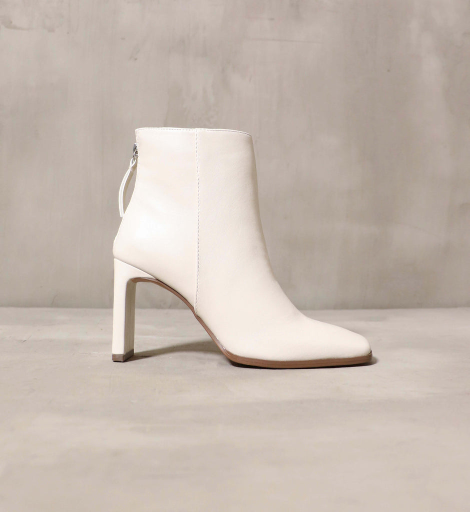 The Not that Basic heeled bootie in white facing to the right.- Elle Bleu