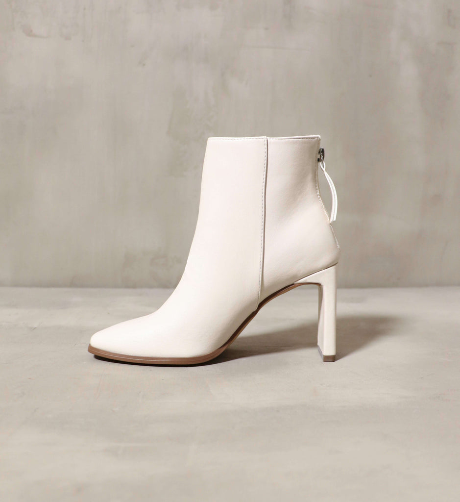 The side silhouette of the Not that Basic ankle bootie in white- Elle Bleu