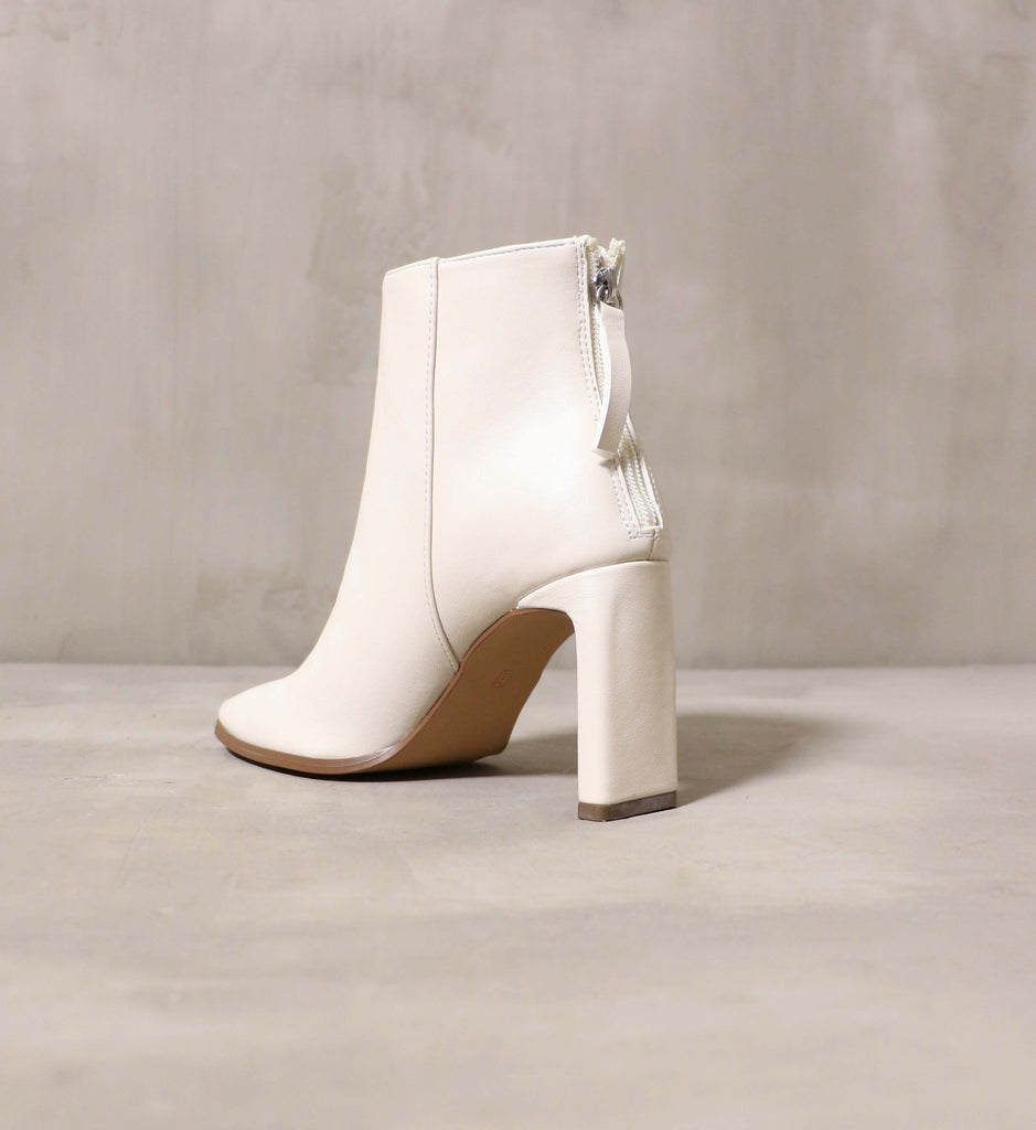 The backside of the Not that basic bootie, showing the zipper and slim block heel- Elle Bleu