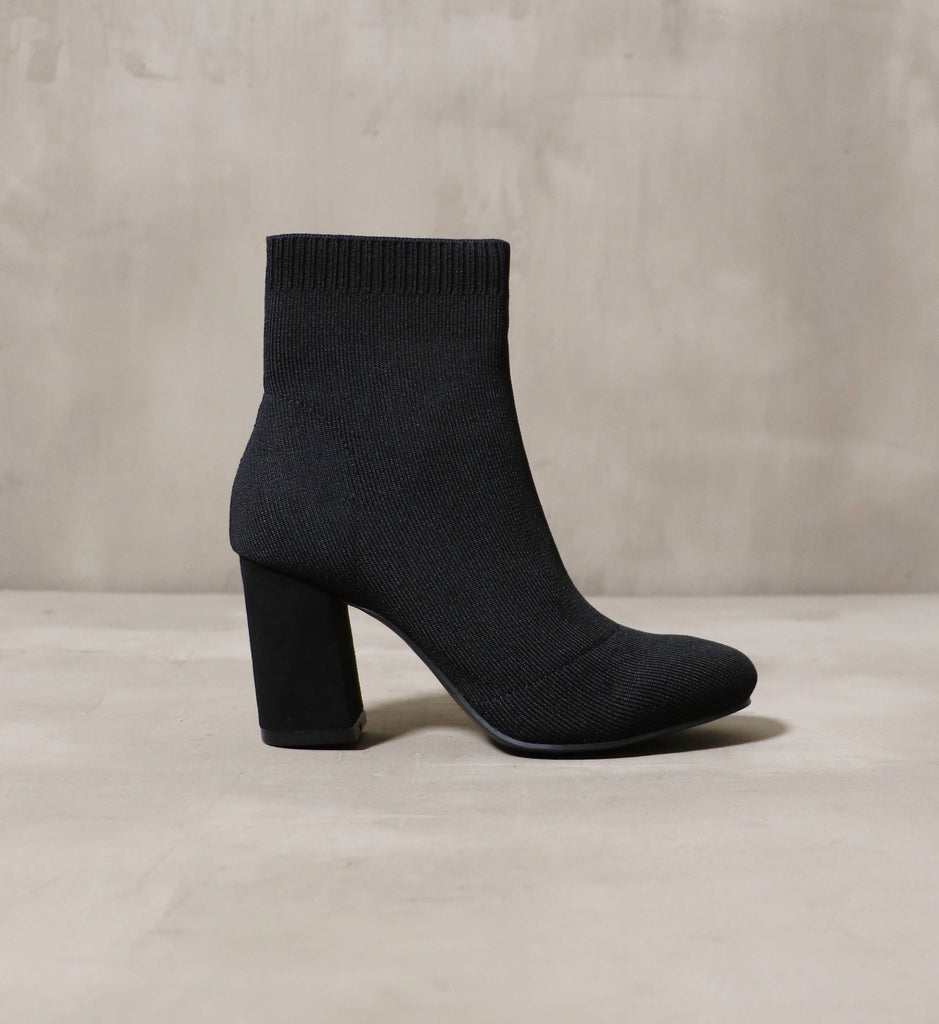 The side profile of the Rumor Has Knit ankle boot.