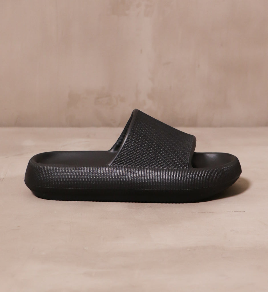 outer side of the late to the foam party slide with molded sole and open toe silhouette