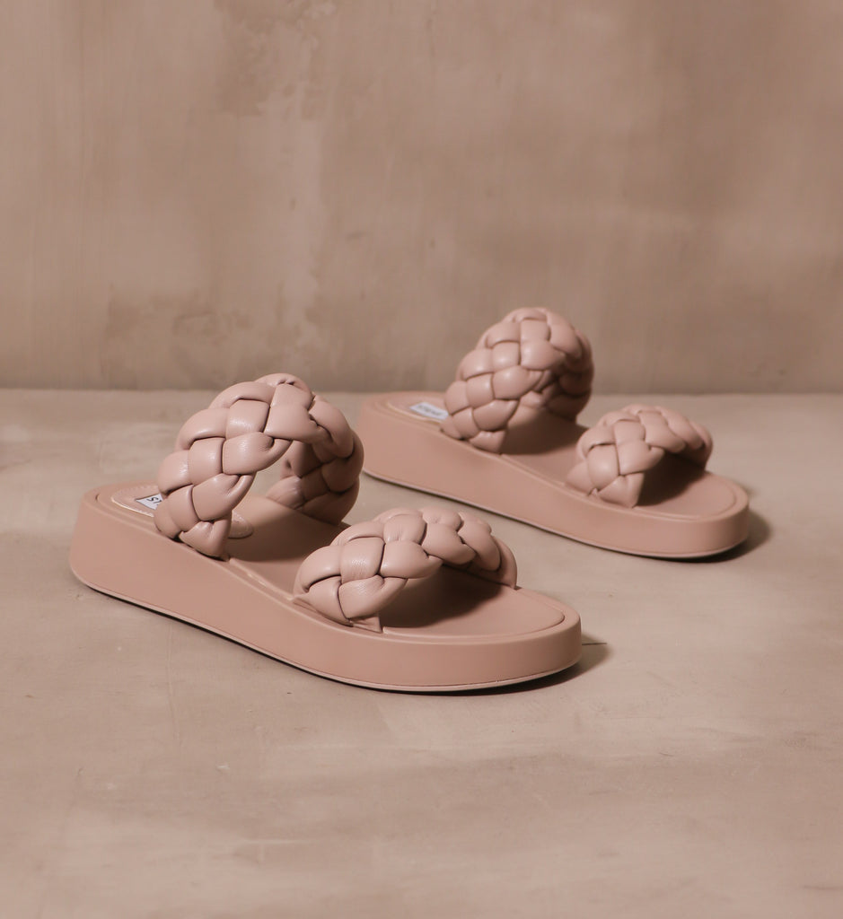 two braided leather straps on a chunky platform sole of the boldly braided sandal