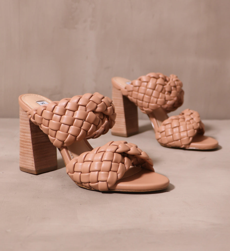 a pair of braid in manhattan open toe block heels on cement background