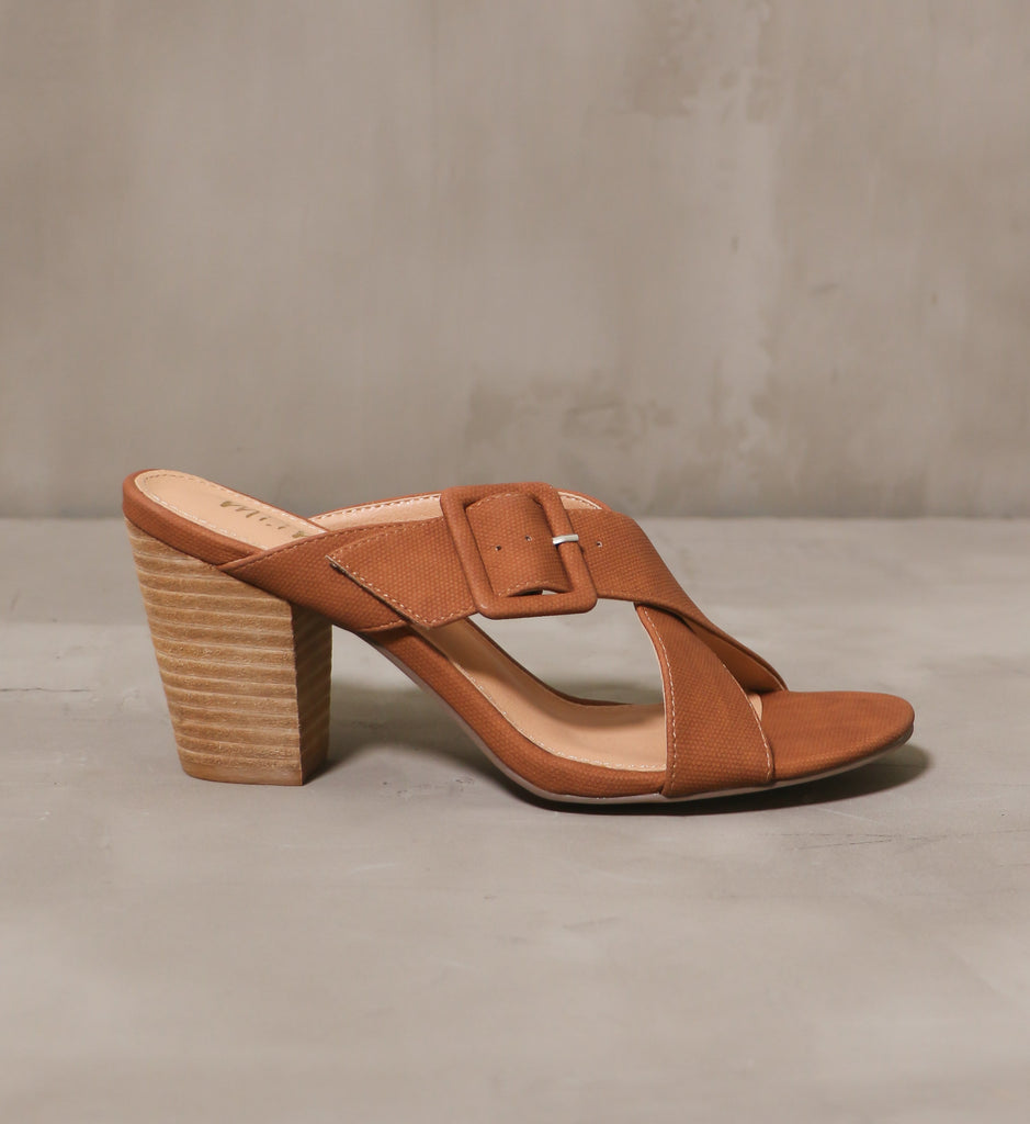 outer side of the fabric buckle on the buckle or nothing heel with brown strap and stacked wood block heel