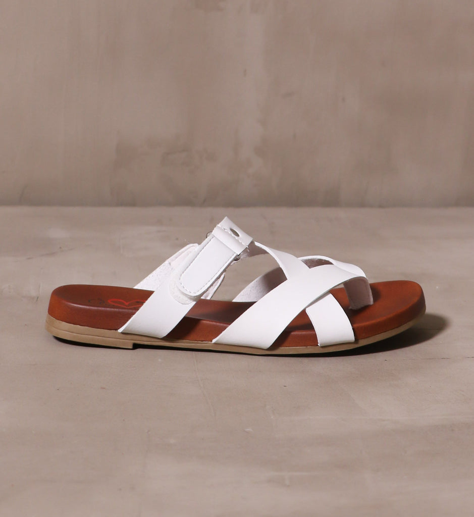 outer side of the casually crossed sandal on cement background