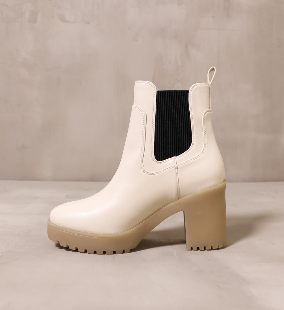 inner side of the off white cream leather upper and black elastic panel on the chelsea you around boot